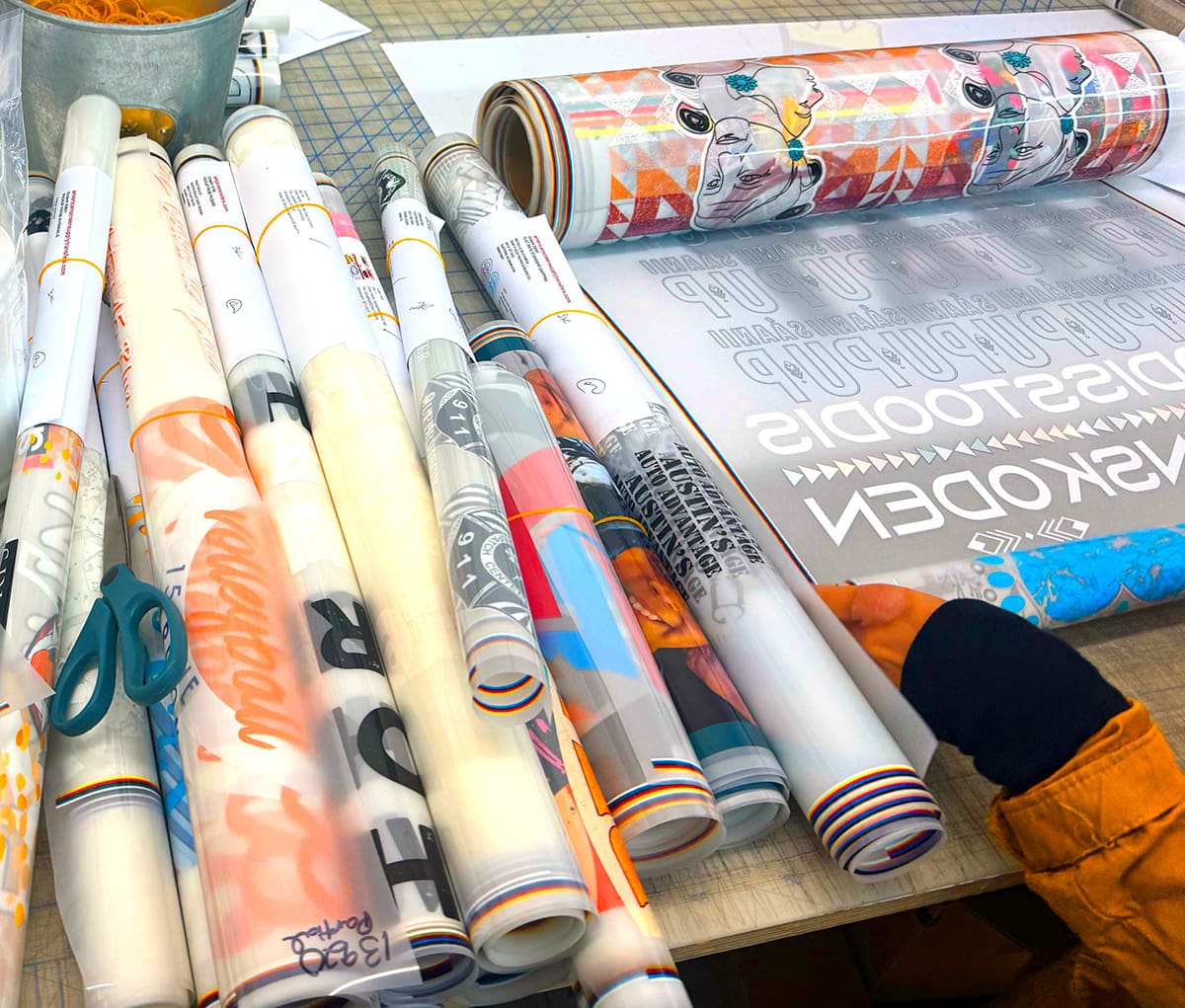 Premium DTF transfer film rolls with colorful printed designs for custom shirt and apparel printing in Arizona